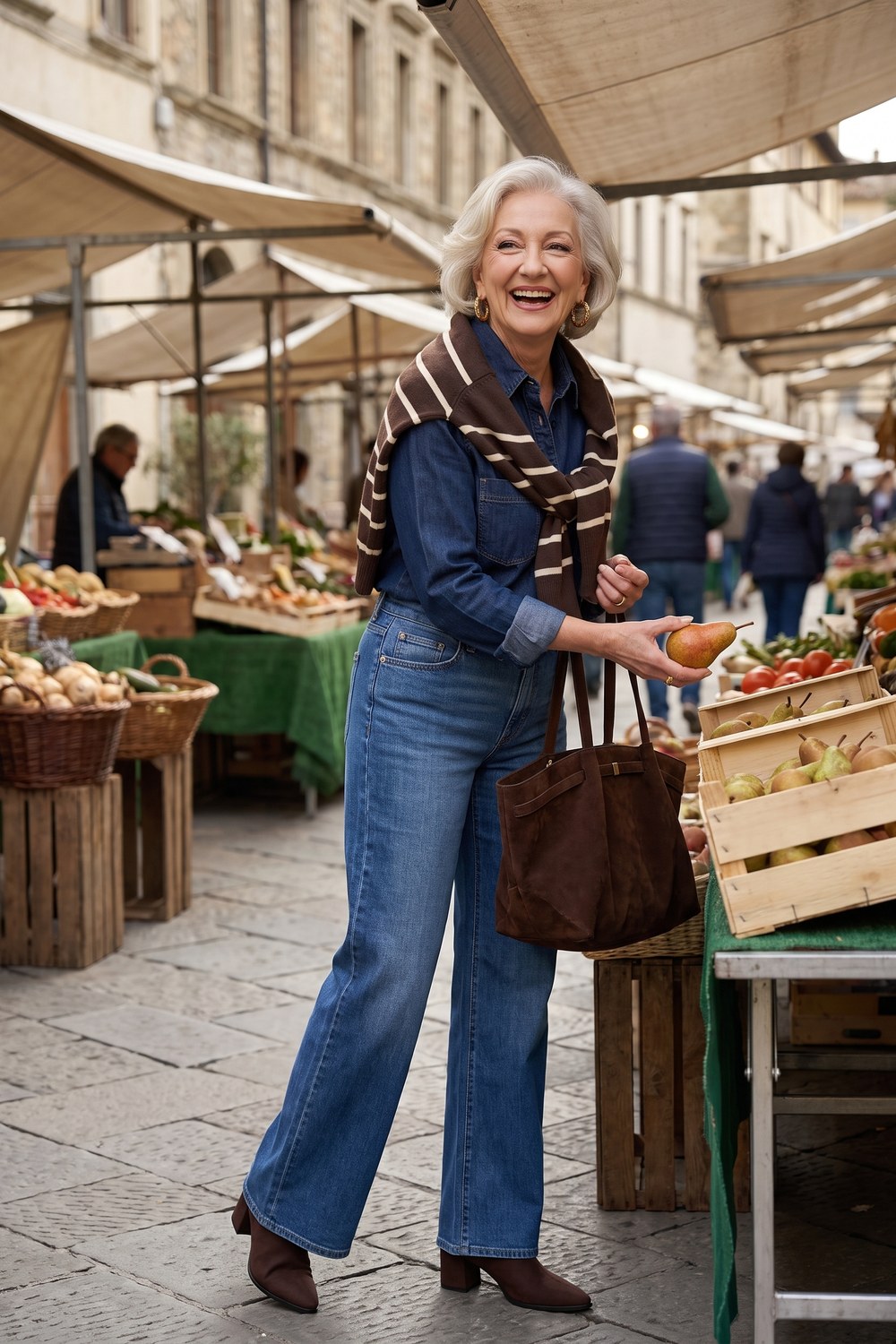 Double denim outfit with a denim shirt, wide-leg jeans and a brown striped sweater over the shoulders