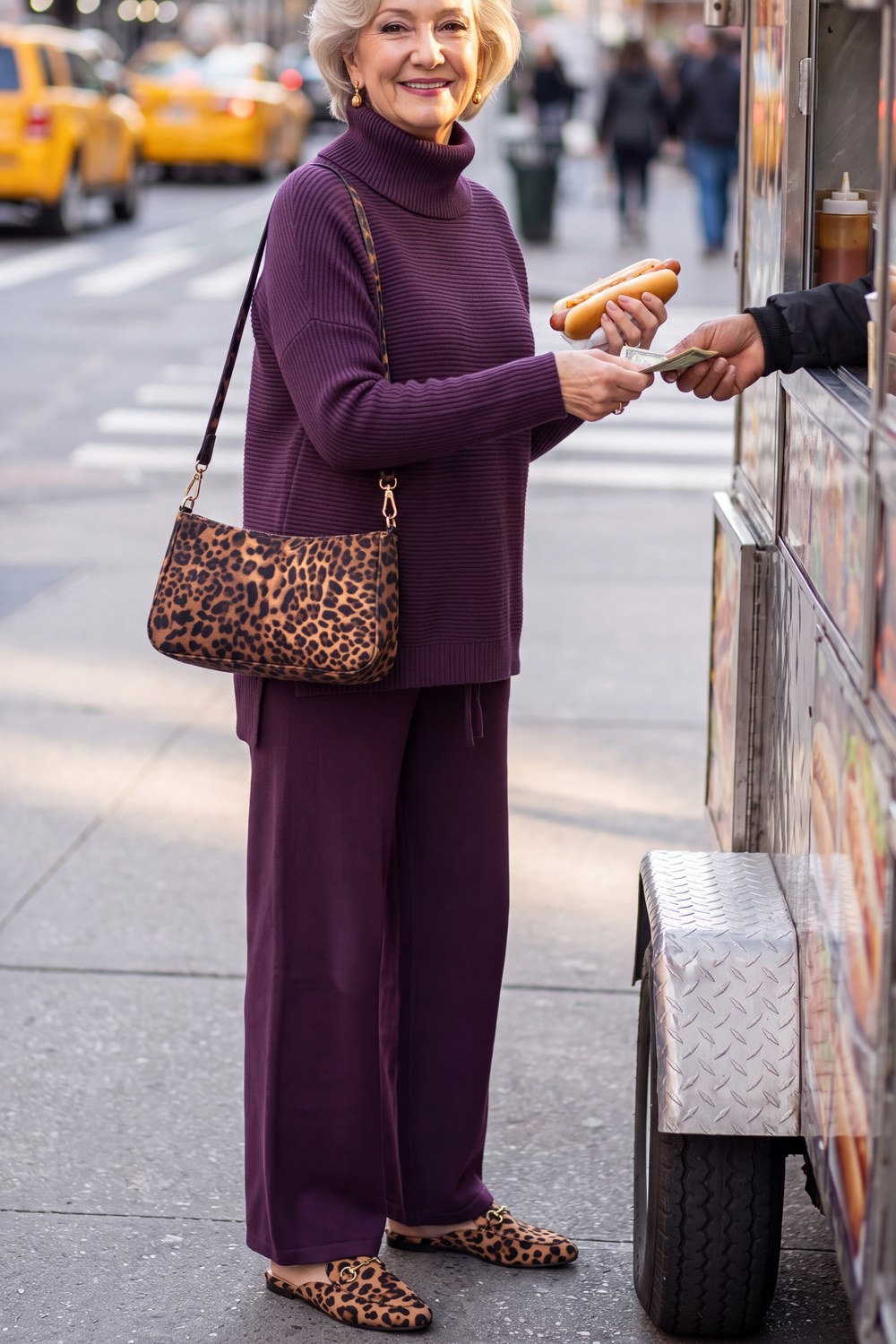 Woman over 50 wearing a plum knit turtleneck and wide-leg pants with leopard loafers